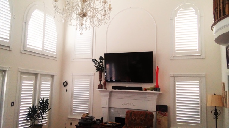 Minneapolis great room with mounted television and arc windows.